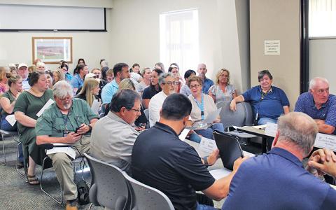 A sizable crowd fills the Macon County Board of Health’s meeting room, where 15 community members spoke at a special meeting.