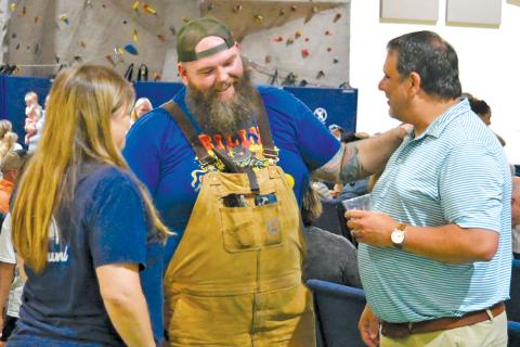 Kyle Bryner, winner of this season’s “BBQ Brawl” talks with Todd Faircloth, executive director of the Foxfire Museum, at the July 27 watch party for the Food Network broadcast.