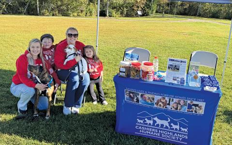 Cashiers-Highlands Humane Society Assistant Shelter Manager Jodi Henkel, Shelter Manager Kaitlyn Villarreal, family, and CHHS shelter dogs Clyde and Jackie prepare for the Blessing of the Animals.