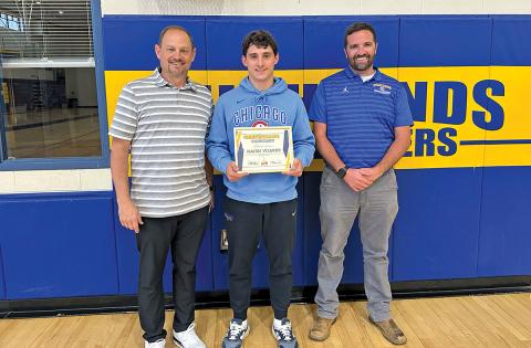 Highlands School Athletic Director Brett Lamb and Ryan Bryson award senior Isaiah Vilardo with the Student-Athlete of the Month award.