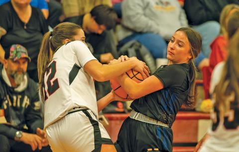 Guard AE Woods wrestles for the ball in Highlands’ opener against Andrews on Nov. 18 in Andrews, NC.