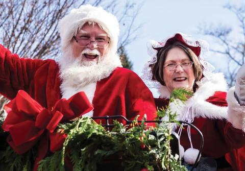 Mr. and Mrs. Clause cheerily wave to parade attendees at the Highlands Christmas Parade  |  Photo courtesy of Visit Highlands NC