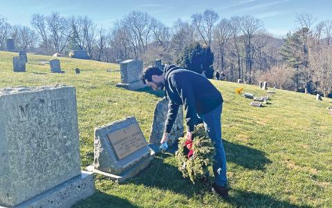 Jayce Kelly places a wreath at the Wreaths Across America event at Highlands Memorial Park on Saturday, Dec.13.  |  Photo courtesy of Phil Potts