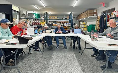 Fishes and Loaves Food Pantry officers and directors review the proposed budget during their board meeting on Feb. 10 in Cashiers.