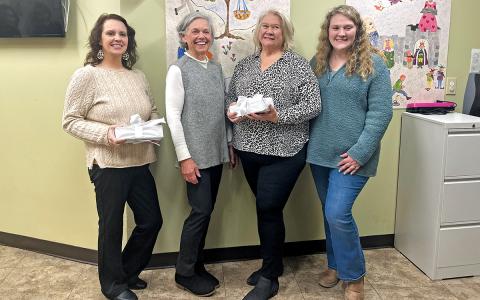 (From L to R) Demitra Passmore, Diane Dickey, Pat Hedden and Sarah Watson pose with gifts at the HCCDC transition ceremony on Thursday, Jan. 29.