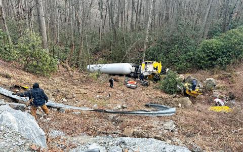 Hilco Transport, Inc. crews sort through the wreckage at the crash site off U.S. 64 on Thursday, Jan. 29. 