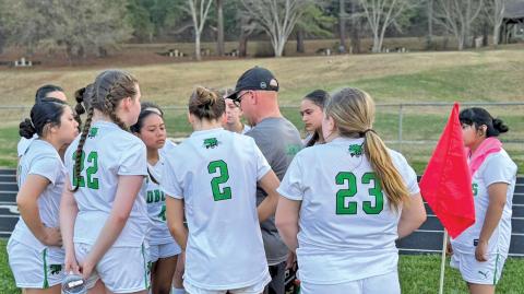 BREC Head Coach Nickalus Pressler discusses tactics with his team at halftime during their match against MEC. The Lady Bobcats drew 1-1.  |  Photo courtesy of BREC