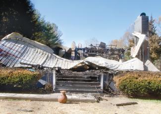 A southern Jackson County couple’s Friendship Lane home of 26 years is a pile of charred debris Friday following a fire there the previous week. They also lost most of their possessions in the Oct. 26 blaze. (Photo by Don Richeson.)