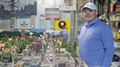 Brian Stiehler shows of his own miniature train town of Highlands in the basement of his home. Stiehler has been a fan of model trains since his childhood.