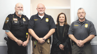Lt. Ron Baumes, Vaughn Estes, chief of police, Ella Fast, city manager and Lt. David Edwards stand inside the newly renovated Sky Valley Police Department during a Dec. 19 open house. 