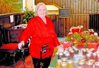 Mary Ann Creswell sets up a table following the Highlands Christmas Parade at the Church of the Incarnation.