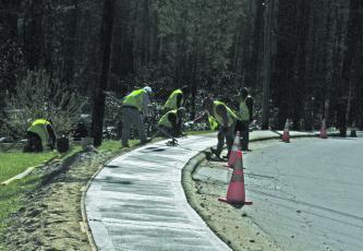 A crew worked to replace a stretch of sidewalk along South 4th Street this week. Capital improvements for the 2020-21 fiscal year have been reduced from previous estimates in the latest version of the Town of Highlands preliminary budget.