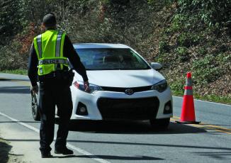 Highlands police officers are no longer manning checkpoints, but are continuing to enforce rules related to COVID-19.