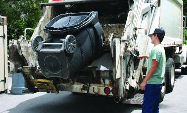 The new bear-resistant garbage cans can be dumped using a lift arm on the trash truck itself, which eliminates the manual lifting of non-compliant cans.