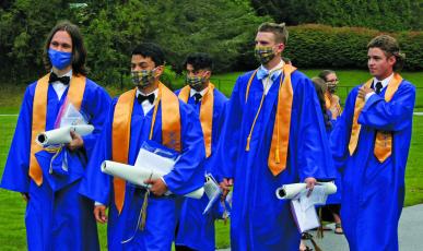 The Highlands School class of 2020 tossed their caps along the track, instead of inside the gymnasium, during Saturday’s graduation ceremony.