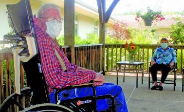 Eckerd Living Center resident Sherman Runion, 75, meets with Mary Jo, his wife of 52 years, during a visit in the living center’s garden last week.