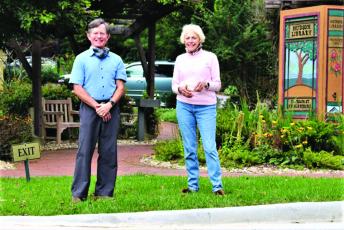 Andy Chmar, president of the Hudson Library board, and Glenda Bell, president of Mountain Findings, admire the handiwork performed on the Hudson Library’s Main Street entrance that has experienced drainage issues for years.