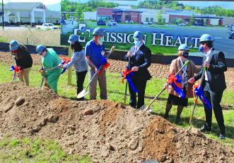 HCA officials turn up the first dirt at the future site of Angel Medical Center at One Center Court. From Left: Becky Dahl, Peggy Ramey, Leslie Vanhook, David Franks, Tim Layman, Karen Gorby, Johnny Mira-Knippel.
