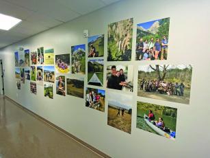 Photo by Christopher Smith/Staff A hallway in the new high school building is filled with photos of students getting field experience and volunteering.