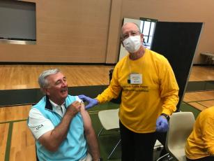 Chris Byrd was happy to receive his booster Covid vaccine shot, thanks to Jack Appel one of the many volunteers.