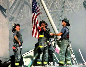 Submitted Photo Firefighters lifting the American Flag during 9/11. 