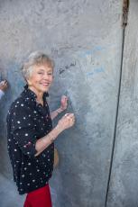 Jane Webb, PAC secretary, signs the wall.