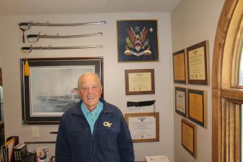 Photo by Christopher Smith/Staff The newest member of American Legion Post 370, Vietnam veteran Rick St. John infront of war memorabilia at his home. 