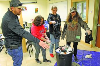 Photo by Christopher Lugo/Staff Macon County recycling coordinator Shaun Cribbs working with students. 