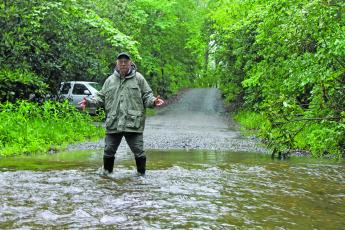 Photo by Christopher Lugo/Staff There is a creek that runs through Hickory Knut Gap Road that sometimes floods to almost two feet deep. Residents like Duncan Greenlee have to drive through the creek daily. 
