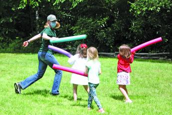 Photo by Kaylee Cook/Staff Education Specialist Paige Engelbrektsson plays with kids during the Buggy Bonanza Camp.