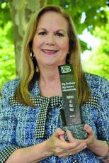 Submitted Photo Board chairman Debbie Charlton holding BBBSWNC’s award.