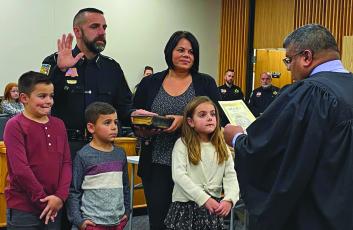 Sheriff Brent Holbrooks takes his oath surrounded by his family.