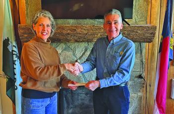 Kaye McHan presents Mountaintop Rotary Club President Michael Lanzilotta with a check for $12,150 to support the club’s annual arts and crafts shows.