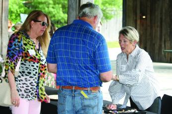 Jannie Bean (right) shows off some of her custom jewelry creations during the Spring Fling at The Bascom on Tuesday.
