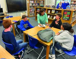 Vickie Betts, a board member at TLLC, volunteers with middle school students.