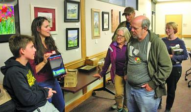 Dr. Rada Petric from the Highlands Biological Station shows attendees of a recent bat lecture at the Macon County Public Library, how they can detect bats flying overhead by sound and what species they area.