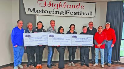 The Highlands Motoring Festival raised $105,000 in 2023, which has been split evenly among three area nonprofits. Pictured are Lester Norris, Steve Ham, Bonnie Potts, David Moore, Faviola Olvera, Cindy Trevathan, Chief Andrea Holland, Mayor Pat Taylor, Ricky Siegel, and Steve Mehder.