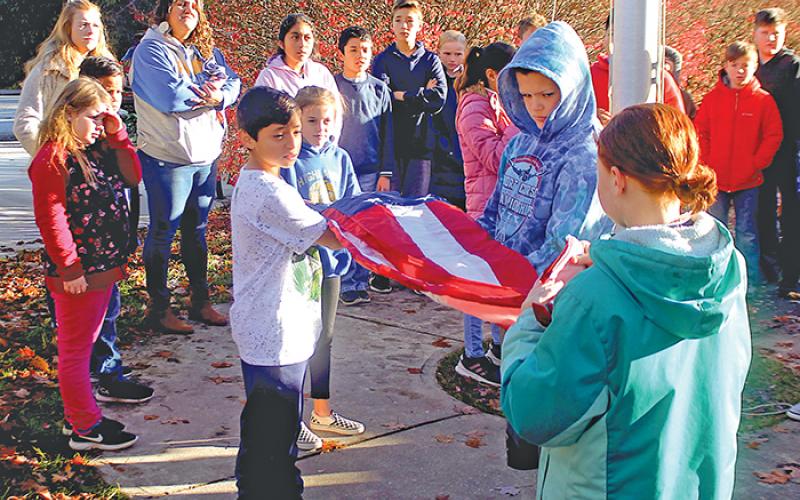 Fifth grade students at Highlands School got a lesson in the proper way to fly, lower and fold the American flag on Friday, Nov. 8.
