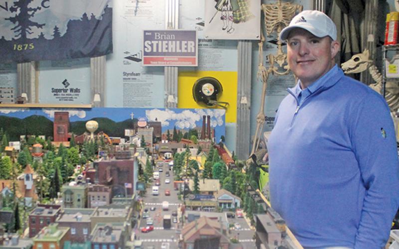 Brian Stiehler shows of his own miniature train town of Highlands in the basement of his home. Stiehler has been a fan of model trains since his childhood.