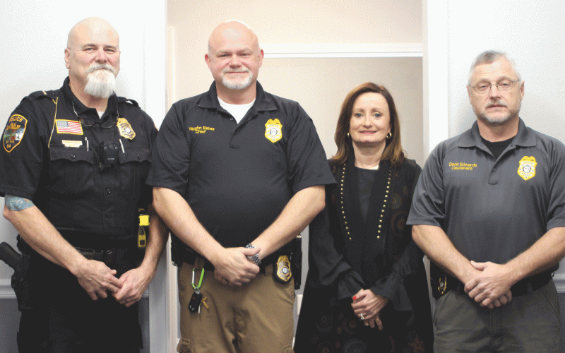 Lt. Ron Baumes, Vaughn Estes, chief of police, Ella Fast, city manager and Lt. David Edwards stand inside the newly renovated Sky Valley Police Department during a Dec. 19 open house. 