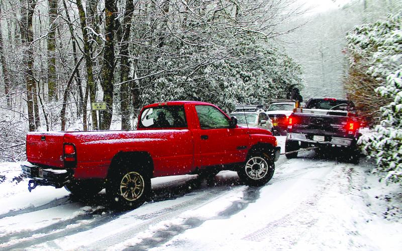 About a dozen vehicles were stranded on NC 106 between Bartram Way and Turtle Pond Road as snow fell on Highlands Friday morning.