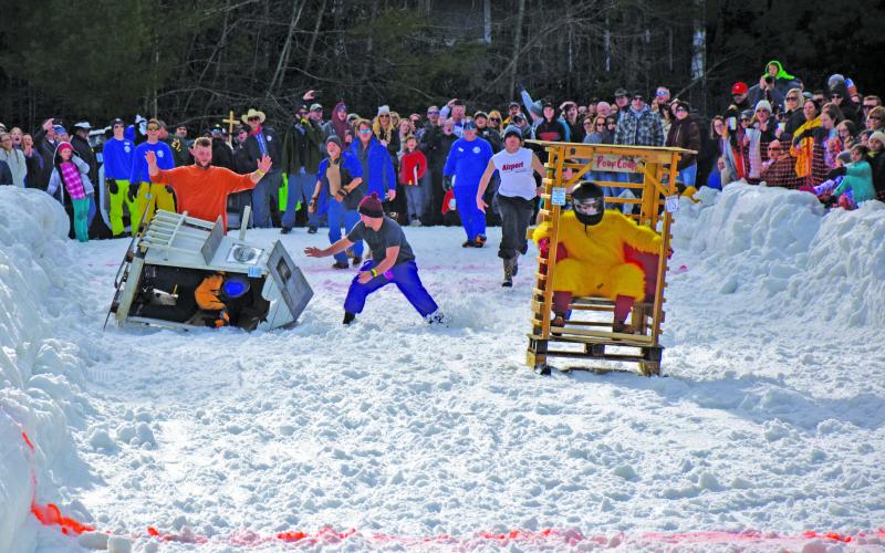 Lance Black, piloting the Poop Coop and his team of Luke Black, Chris Alexander and Jack Alexander, successfully slid to victory in the 14th annual Outhouse Races held Saturday, Feb. 15 at the Sapphire Valley Resort.