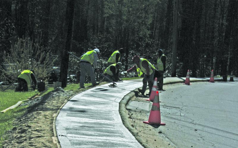 A crew worked to replace a stretch of sidewalk along South 4th Street this week. Capital improvements for the 2020-21 fiscal year have been reduced from previous estimates in the latest version of the Town of Highlands preliminary budget.
