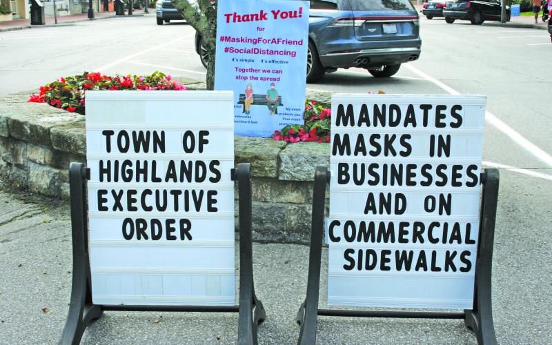 Signs reminding visitors that masks are now mandatory on commercial sidewalks have been placed along Main Street and 4th Street.