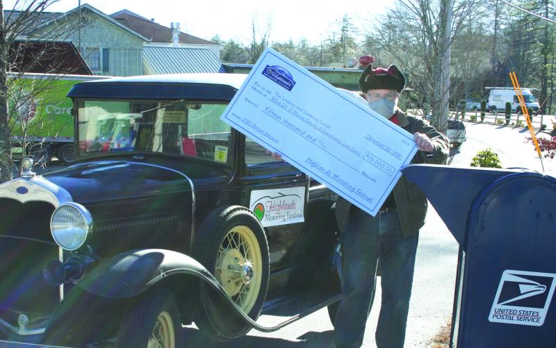 Highlands Motoring Festival organizer Steve Mehder did his best to fit a giant $15,000 check for three nonprofits into the mailbox.
