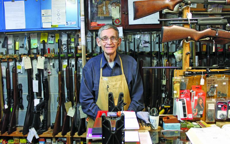 Photo by Will Woolever Buck Ledbetter stands behind the counter of his store, Buck’s Gun Shop, in Franklin.