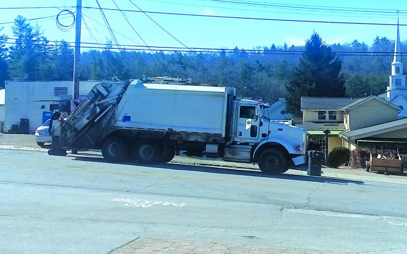 A Town of Highlands sanitation crew picks up commercial trash along Oak Street on Wednesday morning.