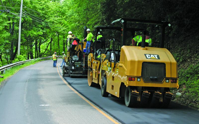 Road resurfacing on US 64 was underway Tuesday after a two-week hiatus.
