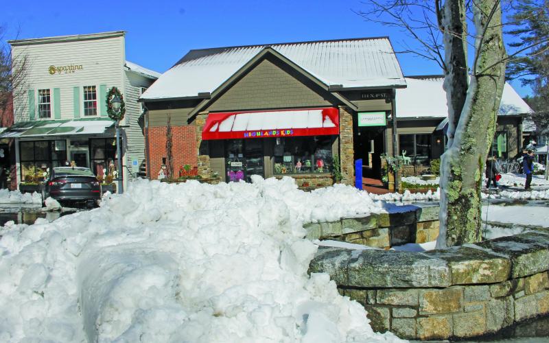 Photo by Christopher Lugo/Staff Snow piled on Main Street after town employees plowed the street.
