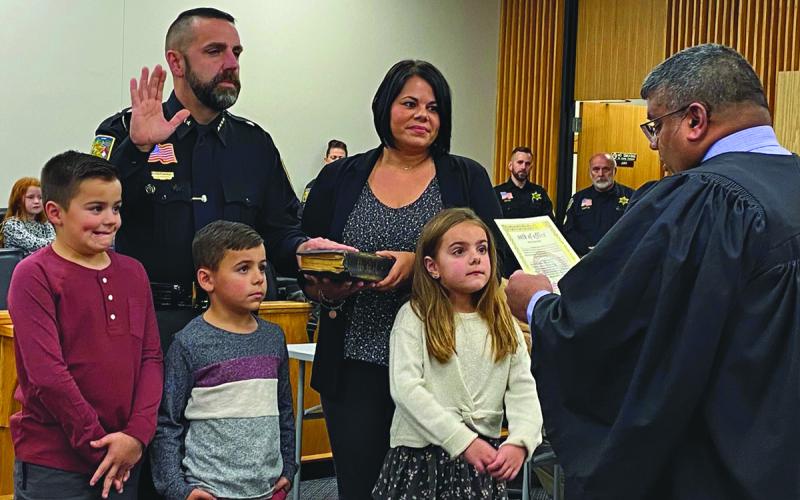 Sheriff Brent Holbrooks takes his oath surrounded by his family.